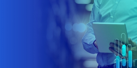 Person in light blue shirt holding tablet, blurred background, abstract shapes.