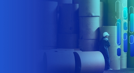 Worker in protective gear near industrial paper rolls, gradient overlay and abstract shapes.