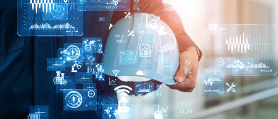 Person holding white hard hat with digital icons and graphs, blurred background.